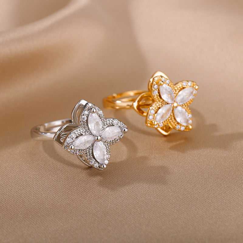 Velora Ring flower design anxiety ring in silver and gold with four petal crystal accents