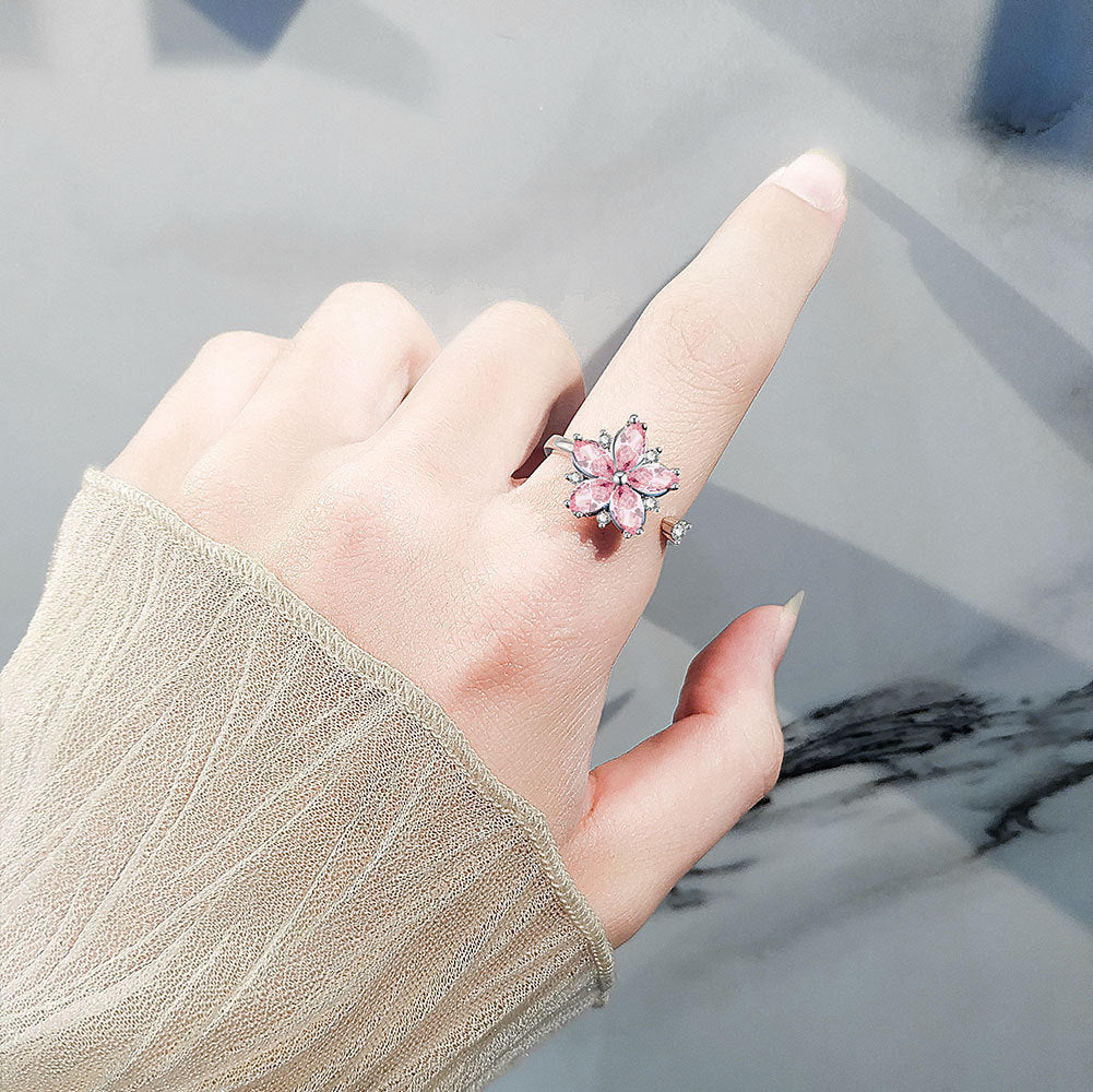 Velora flower spinner ring for women with pink stone petals worn on finger