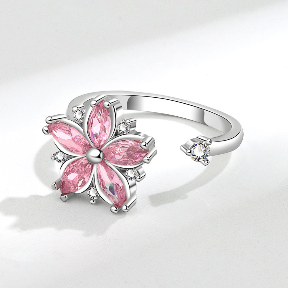 Velora flower spinner ring for women with pink gemstone petals and silver band open design