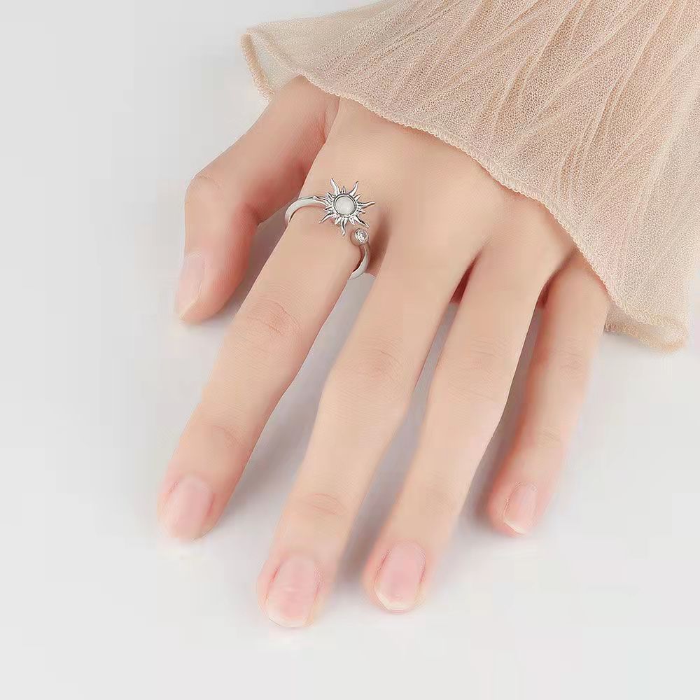 Velora Ring featuring elegant star and moon jewelry ring design worn on finger with beige sheer sleeve